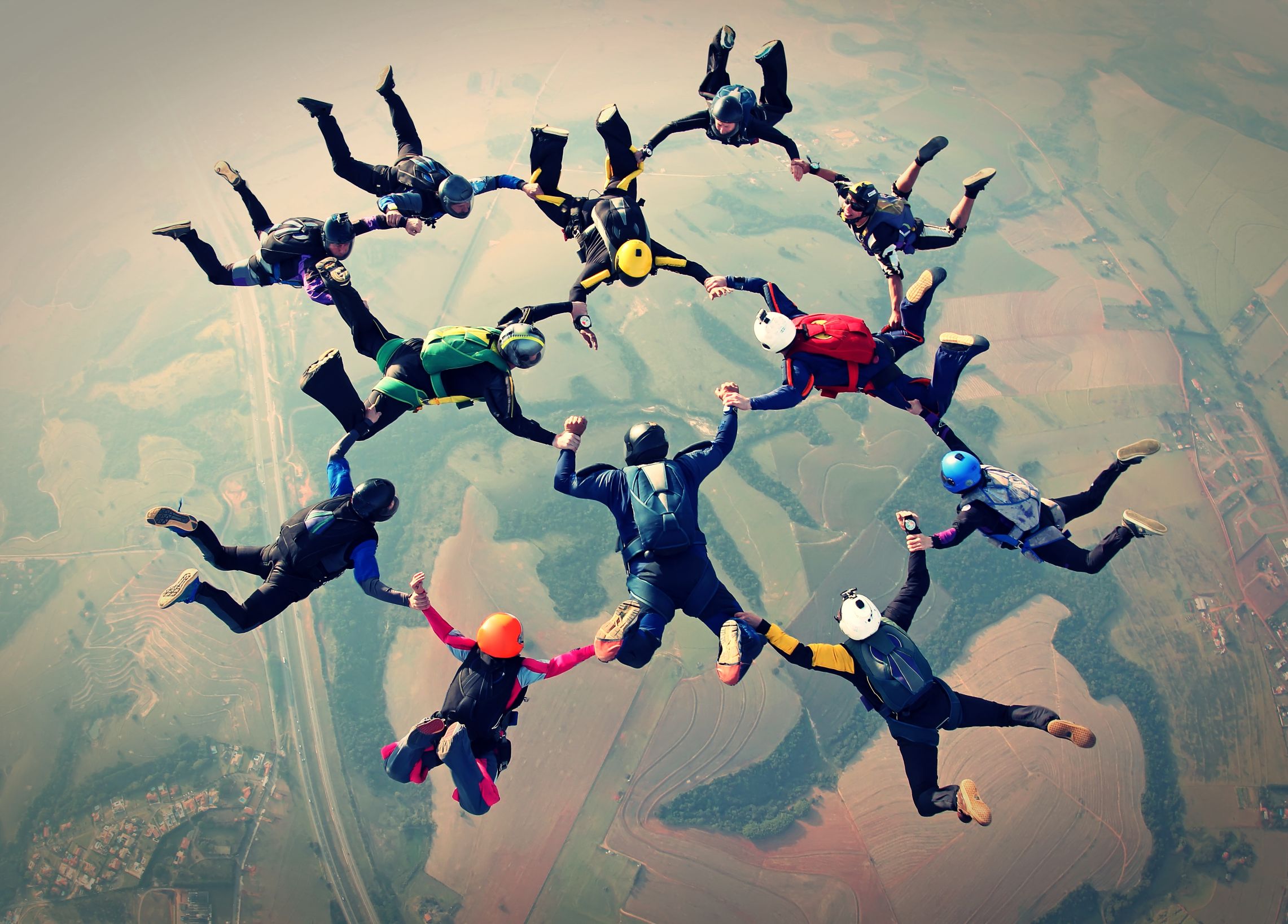 An image showing skydivers forming a shape to signify collaboration.